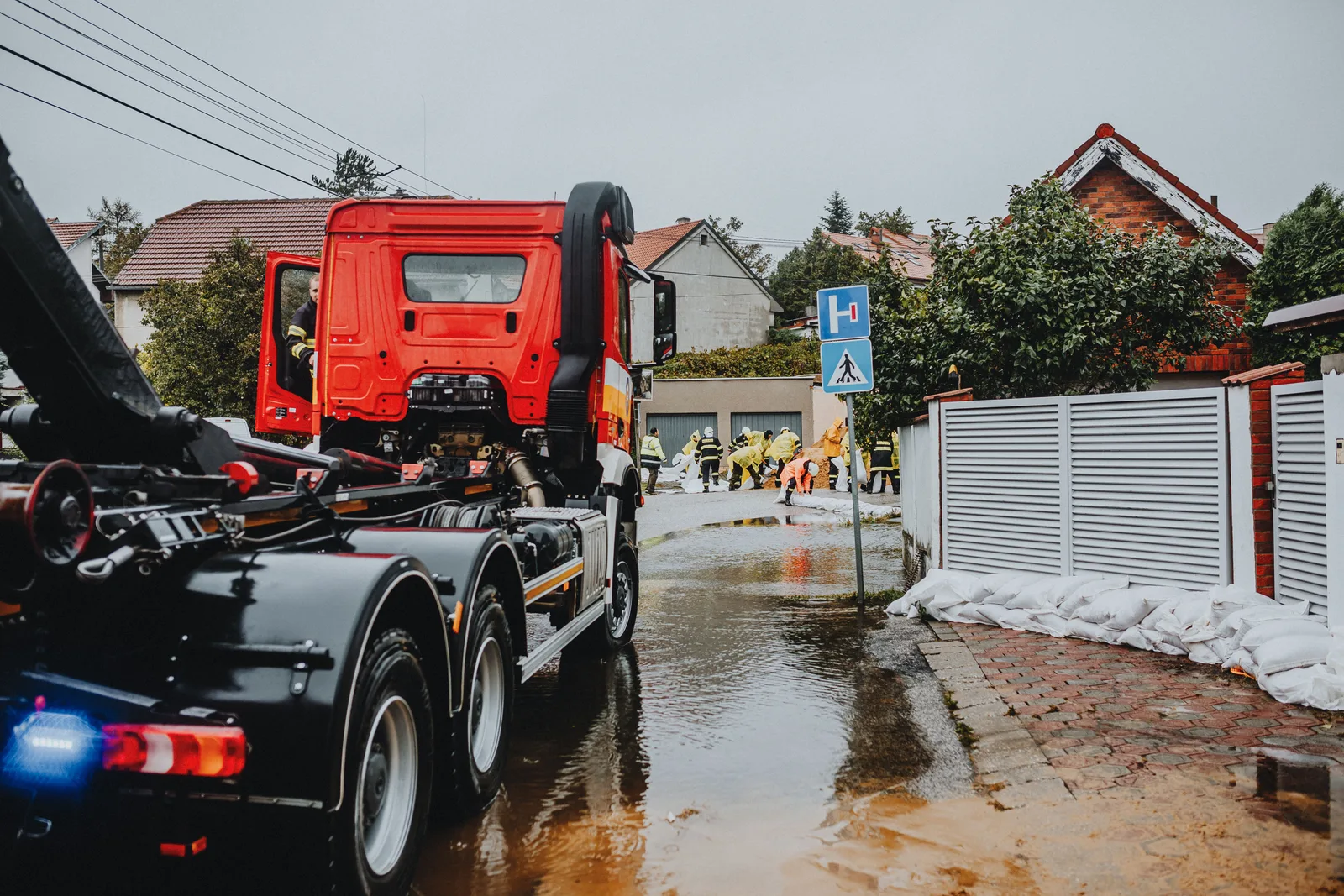 Emergency vehicles and personnel addressing urban flooding caused by heavy rains. 5 cross-border rules for Canadian restoration firms serving US clients