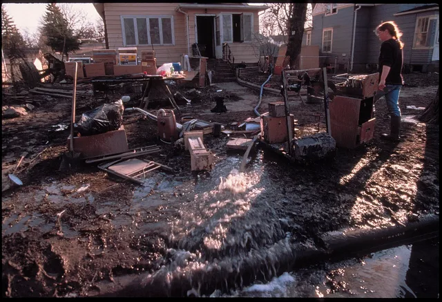 Grand Forks, ND, April 15, 1997 - Residents of Grand Forks muck out their homes and use pumps to remove water from basements. The Red River flooded and damaged many homes in the area with mud and water. FEMA/Michael Rieger. Water mitigation recovery: CSA standards and provincial codes for Canadian crews