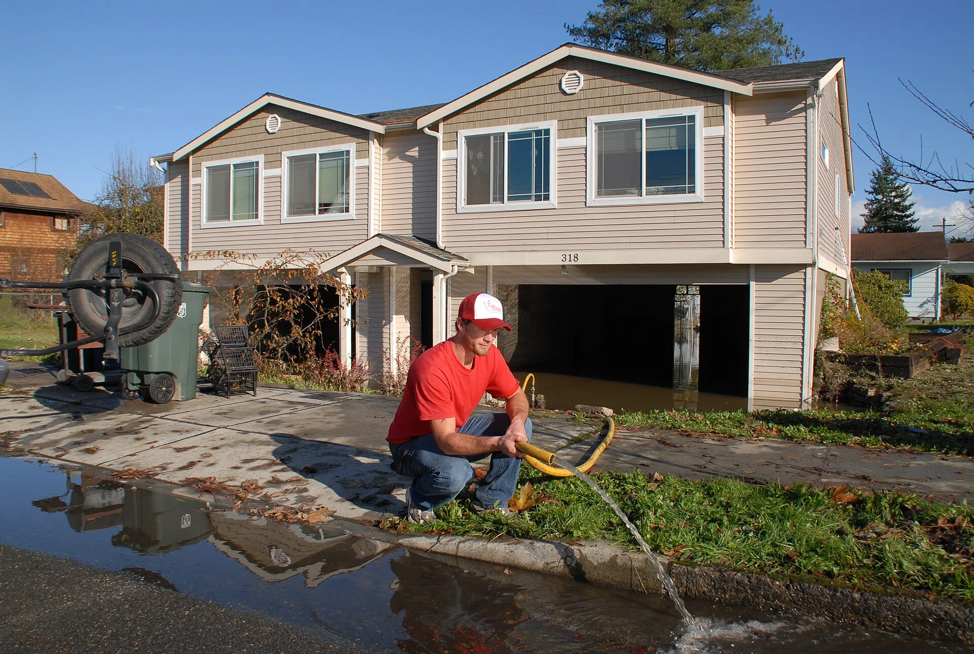 Sultan, WA, November 11, 2006 -- Mitch McKron pumps water from the basement of his mitigated home that he had just raised in time to prevent it from flooding. Record rains have swollen many western Washington Rivers that have breached their levees and are flooding roads, property and towns. MARVIN N. Water Mitigation Vancouver: Flood Risks and Crew Planning