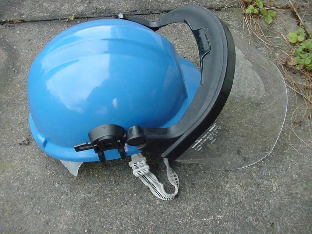Workman's safety helmet with visor and chinstrap. Which skills does new water restoration training need to cover first?